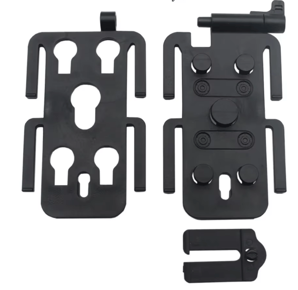 Black plastic mounting bracket kit with keyhole cutouts, screw holes, and a small separate clip piece, shown on a plain white background.
